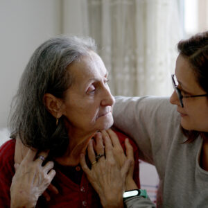 Woman hugging her elderly mother