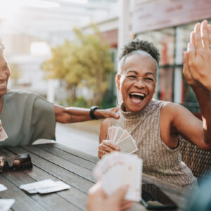 Senior women friends playing cards